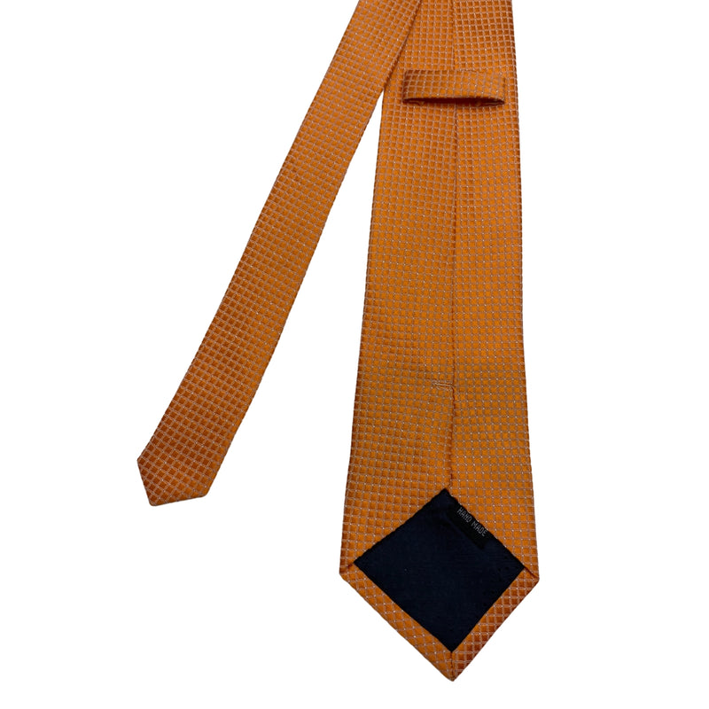 Orange patterned tie on a white background